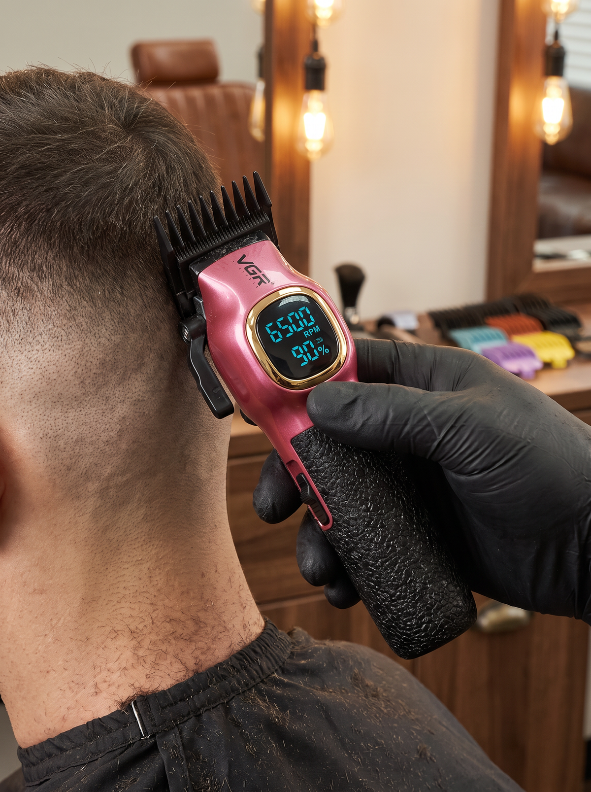 VGR pink cordless clipper with LED display cutting a fade in a barbershop