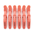 Coral crocodile sectioning clips on white