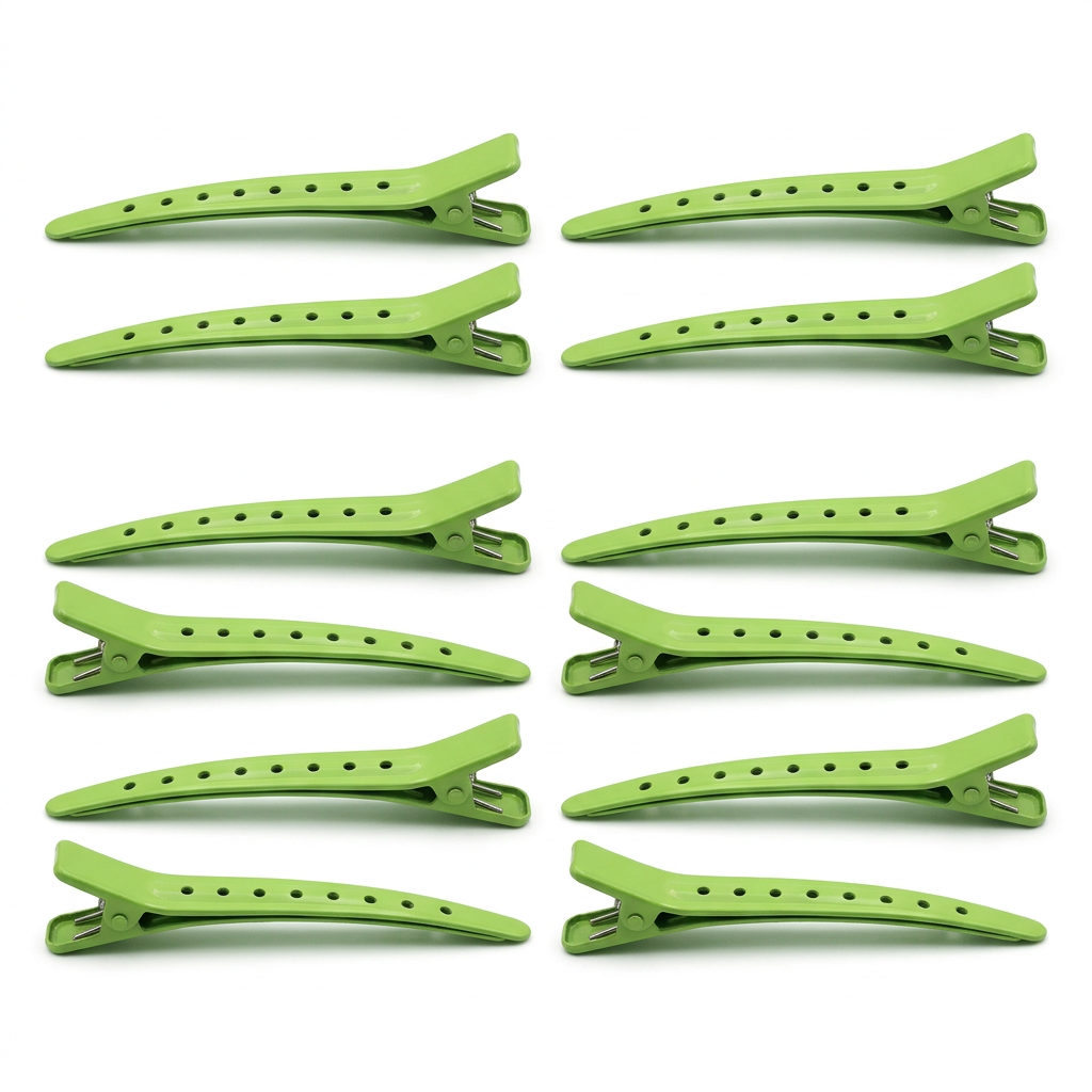 Twelve green duck-bill hair sectioning clips on white background